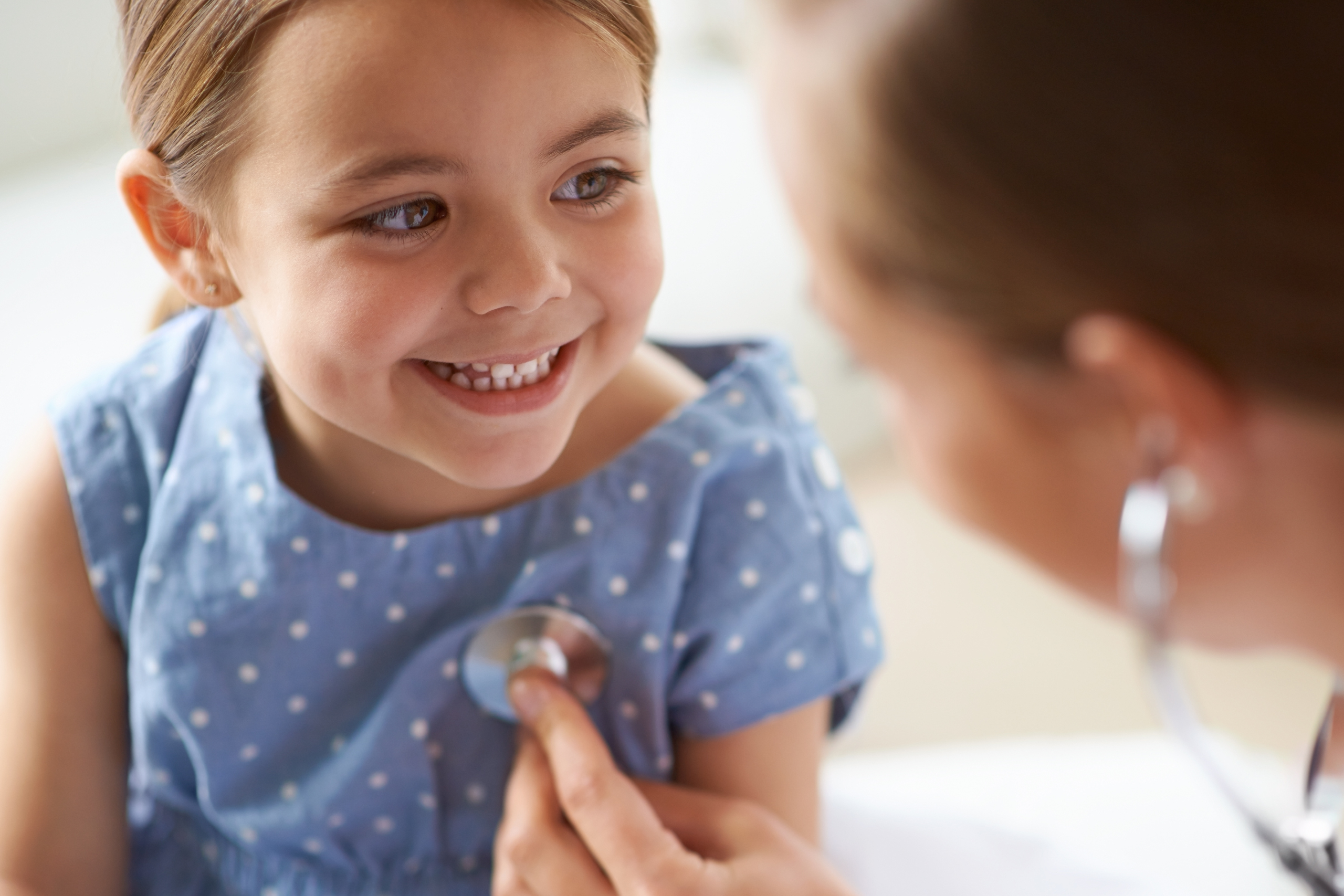 physician listening to child's heart